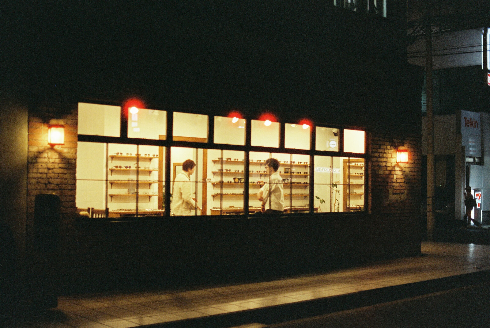 An eyewear house, lit at night.